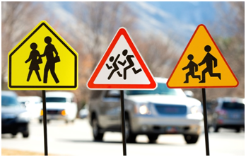 From left to right: Pedestrian warning signs for the U.S., Poland, and Russia