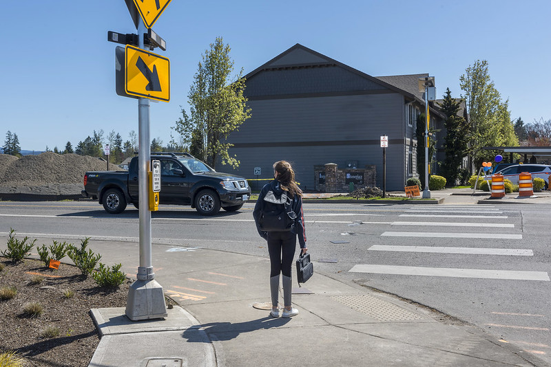 Person waiting at marked crosswalk