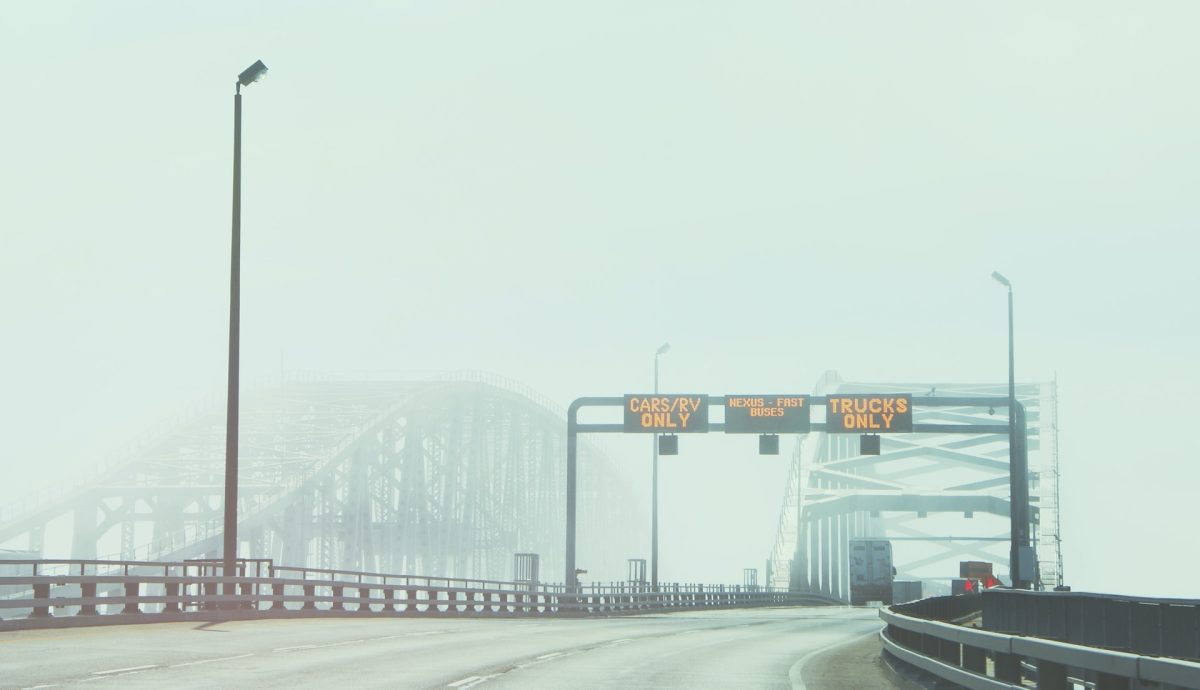 Bridge with signs in fog